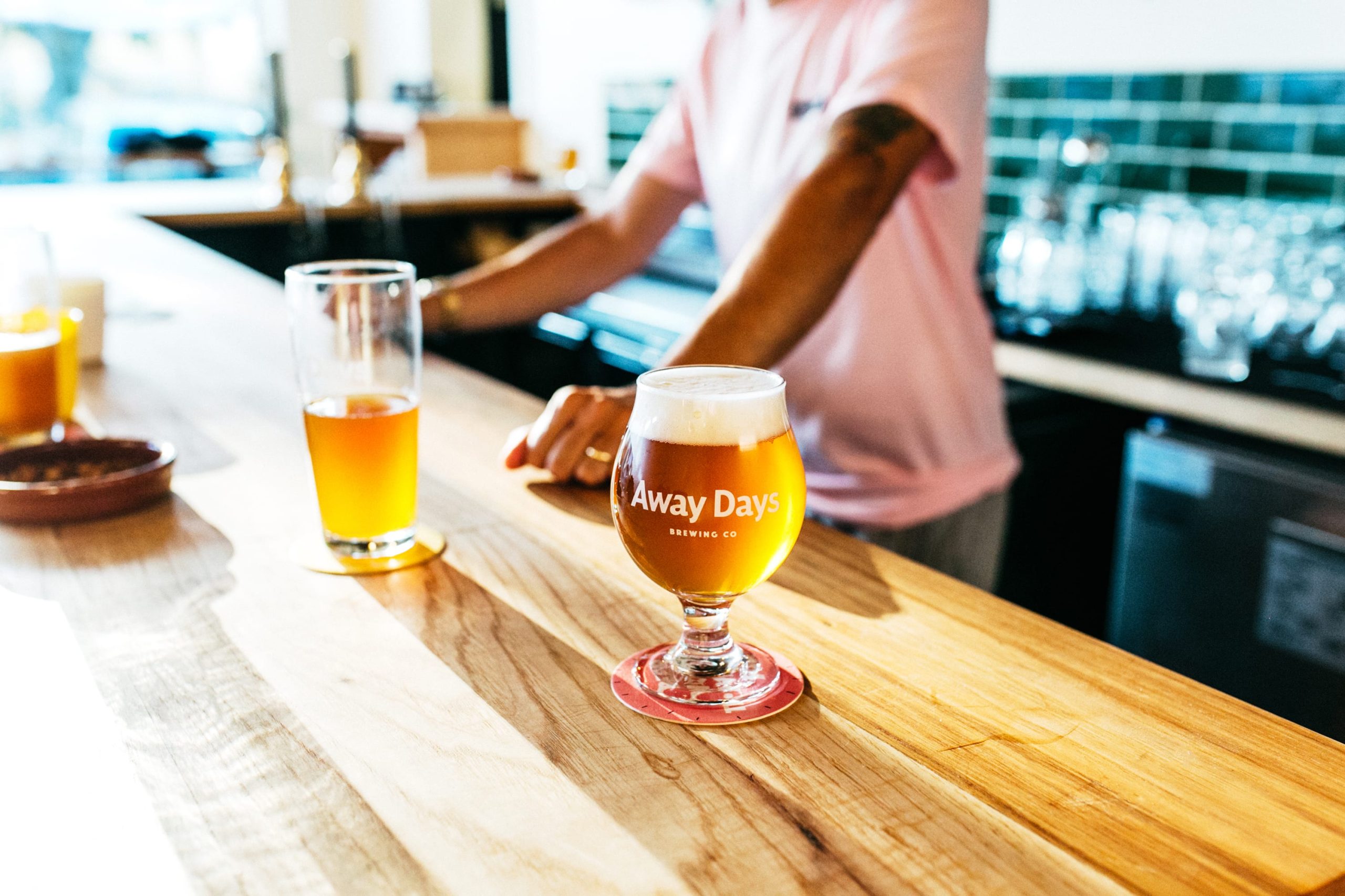 Away Days Brewing Co. Bar in the brewery with glass on